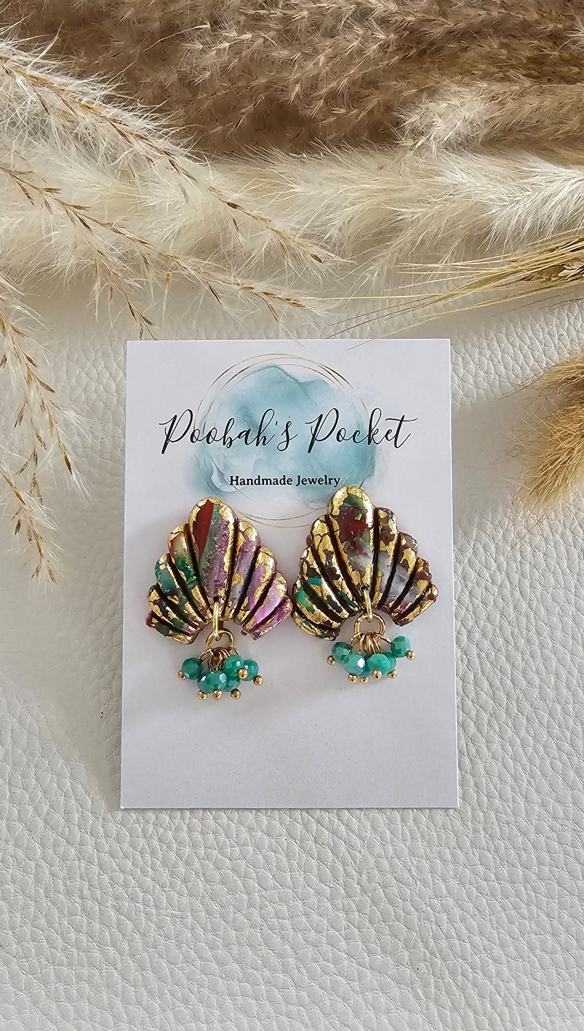 multicolored polymer clay earrings shaped as a shell with hanging beads