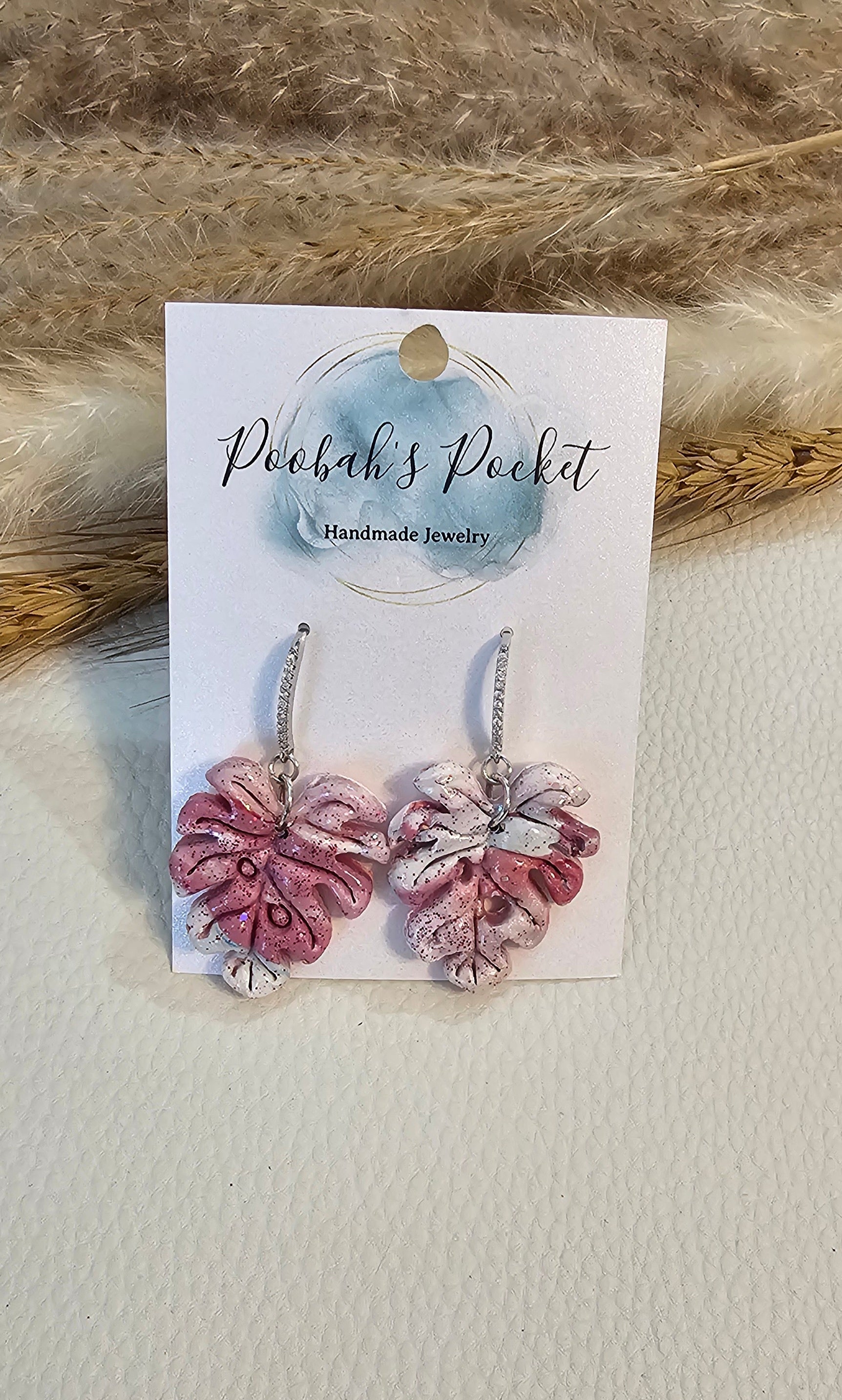 pair of pink and white leaf shape earrings